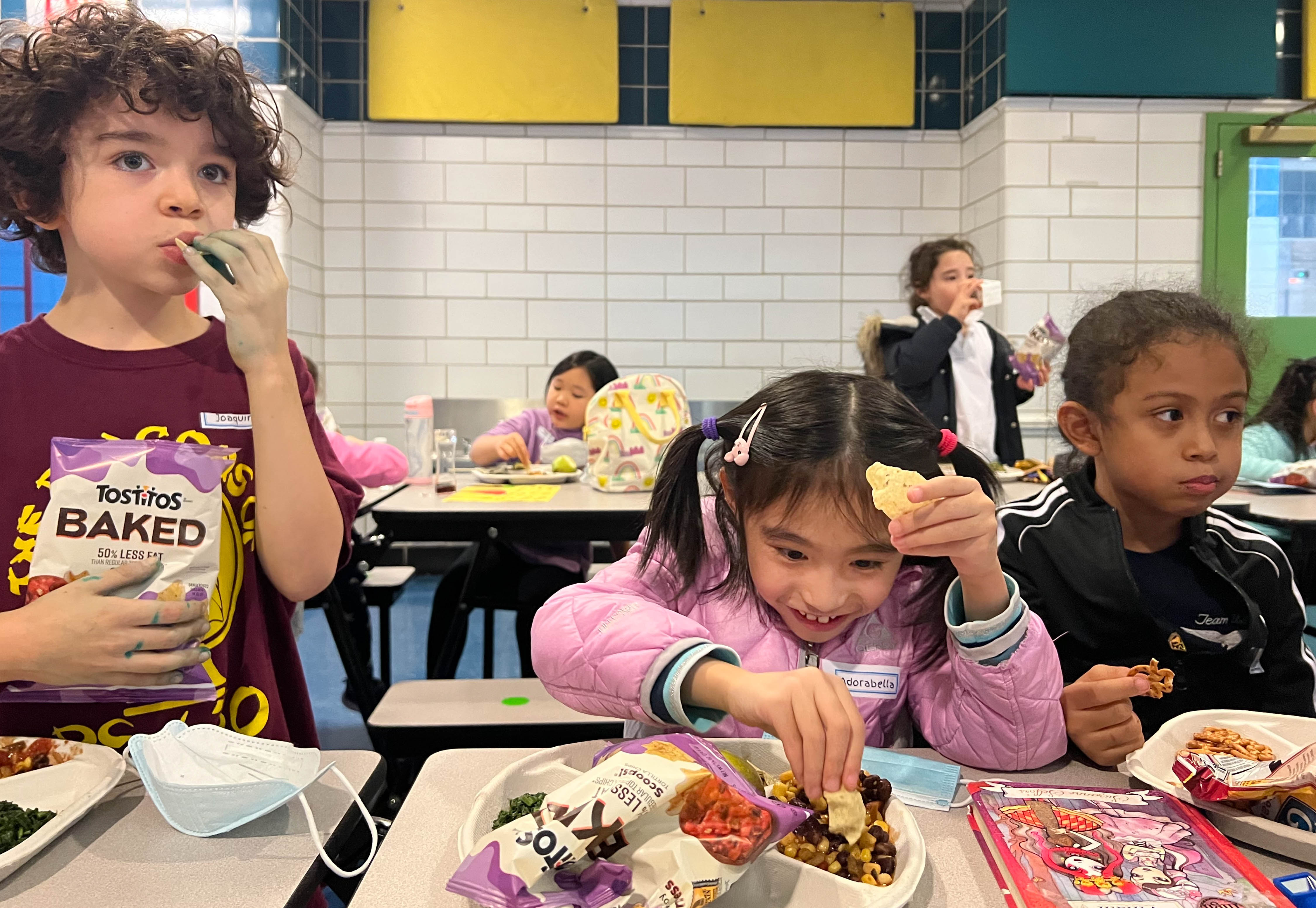 A kid digs into a school cafeteria meal.