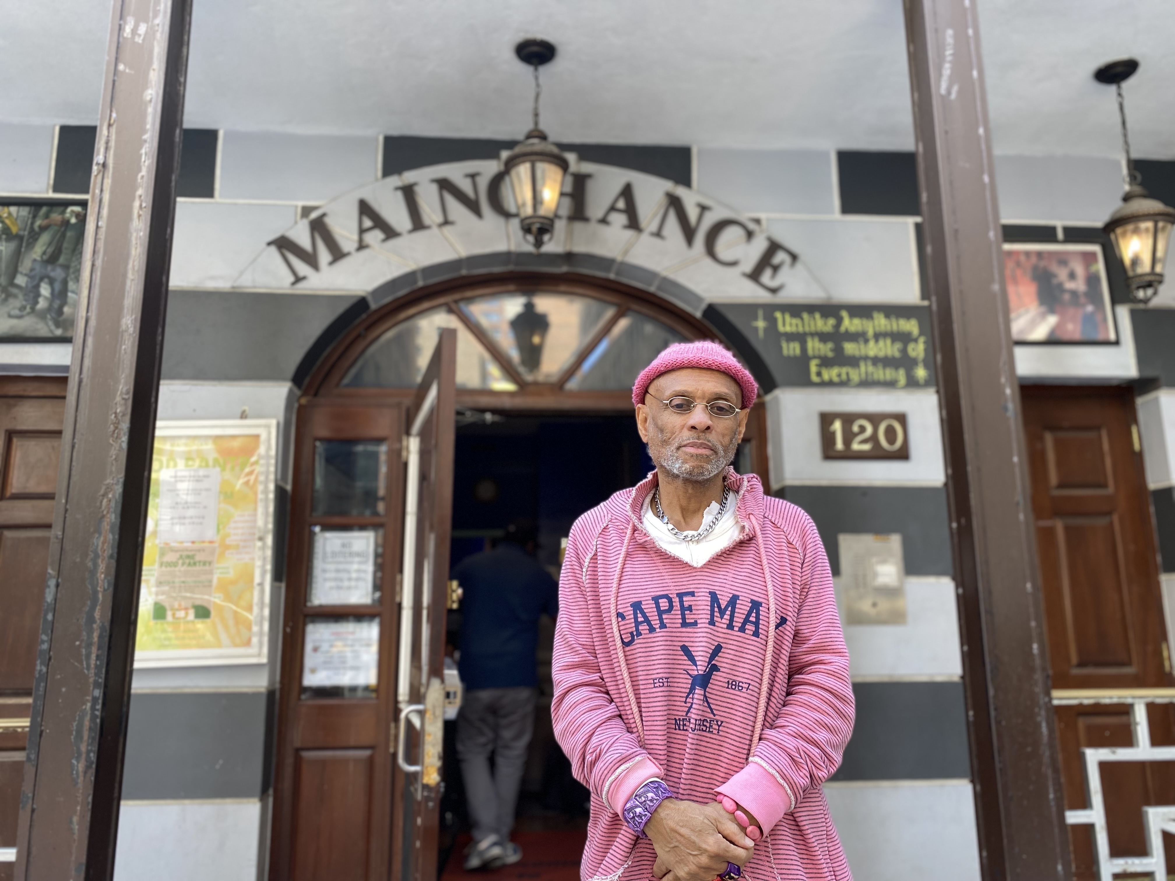 Brady Crain, executive director of MainChance, wears a pink sweater outside of the Midtown drop-in center.