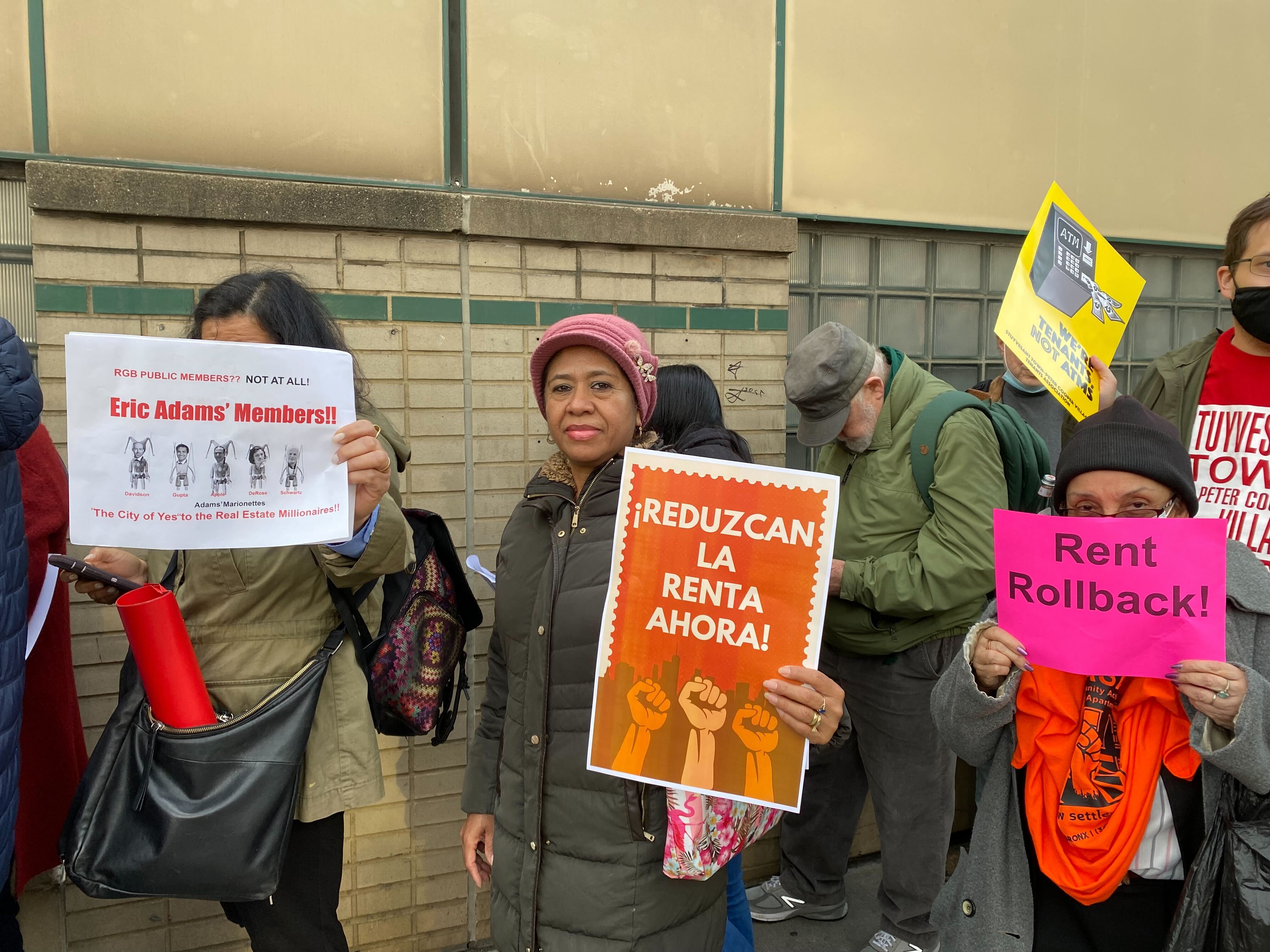 Residents protest outside of Tuesday night's meeting before the board considers future raises in rent prices.