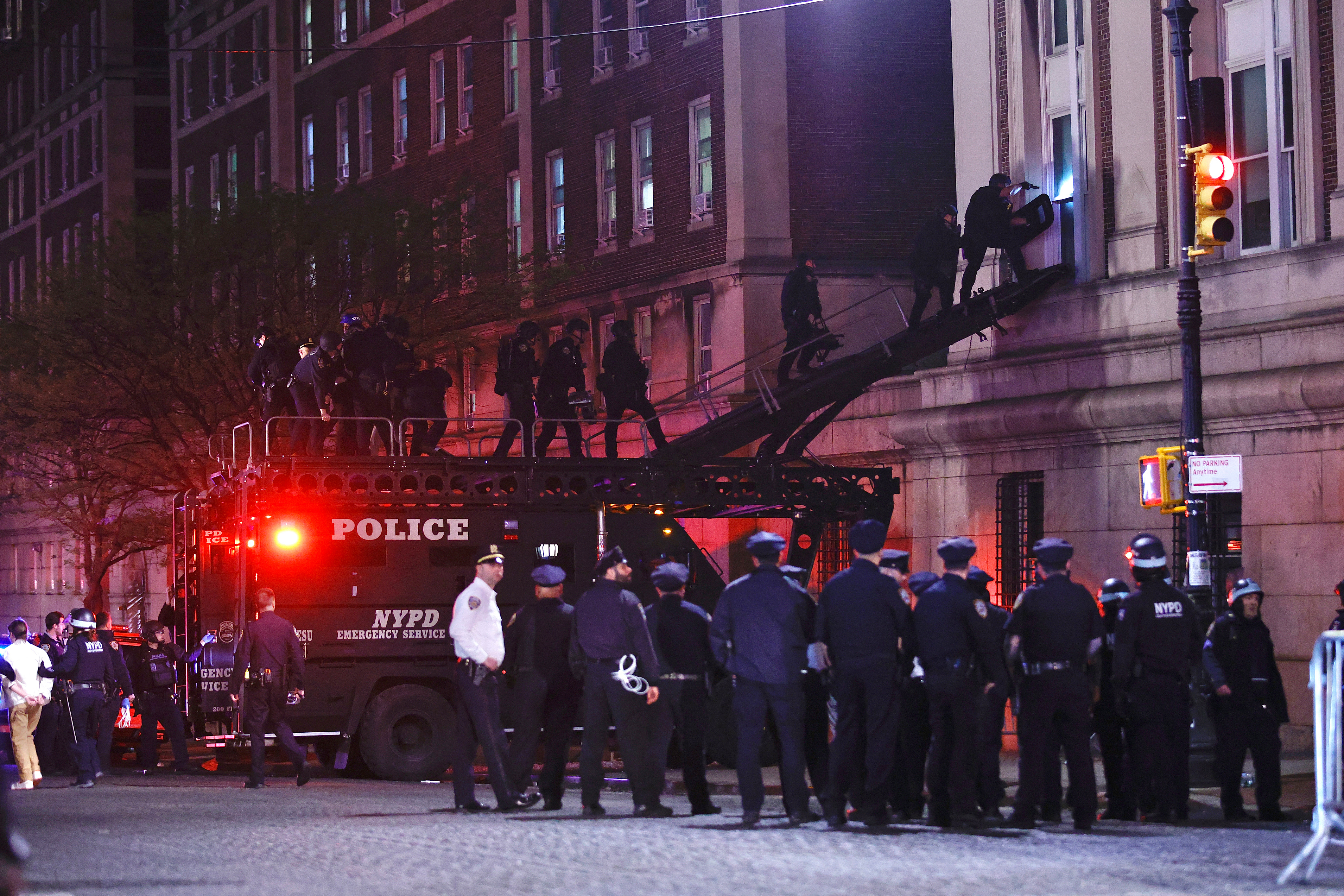 NYPD officers in riot gear break into a building at Columbia University on Tuesday, April 30 2024.