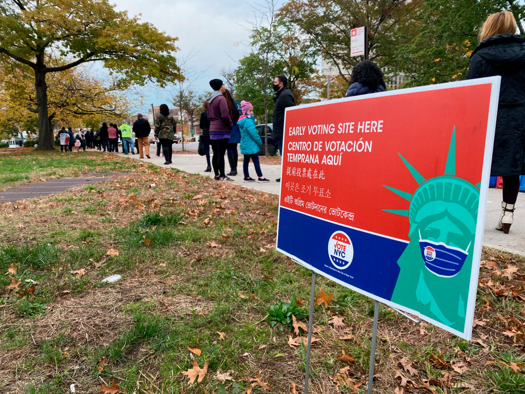 People line up outside of an early polling site in Queens.