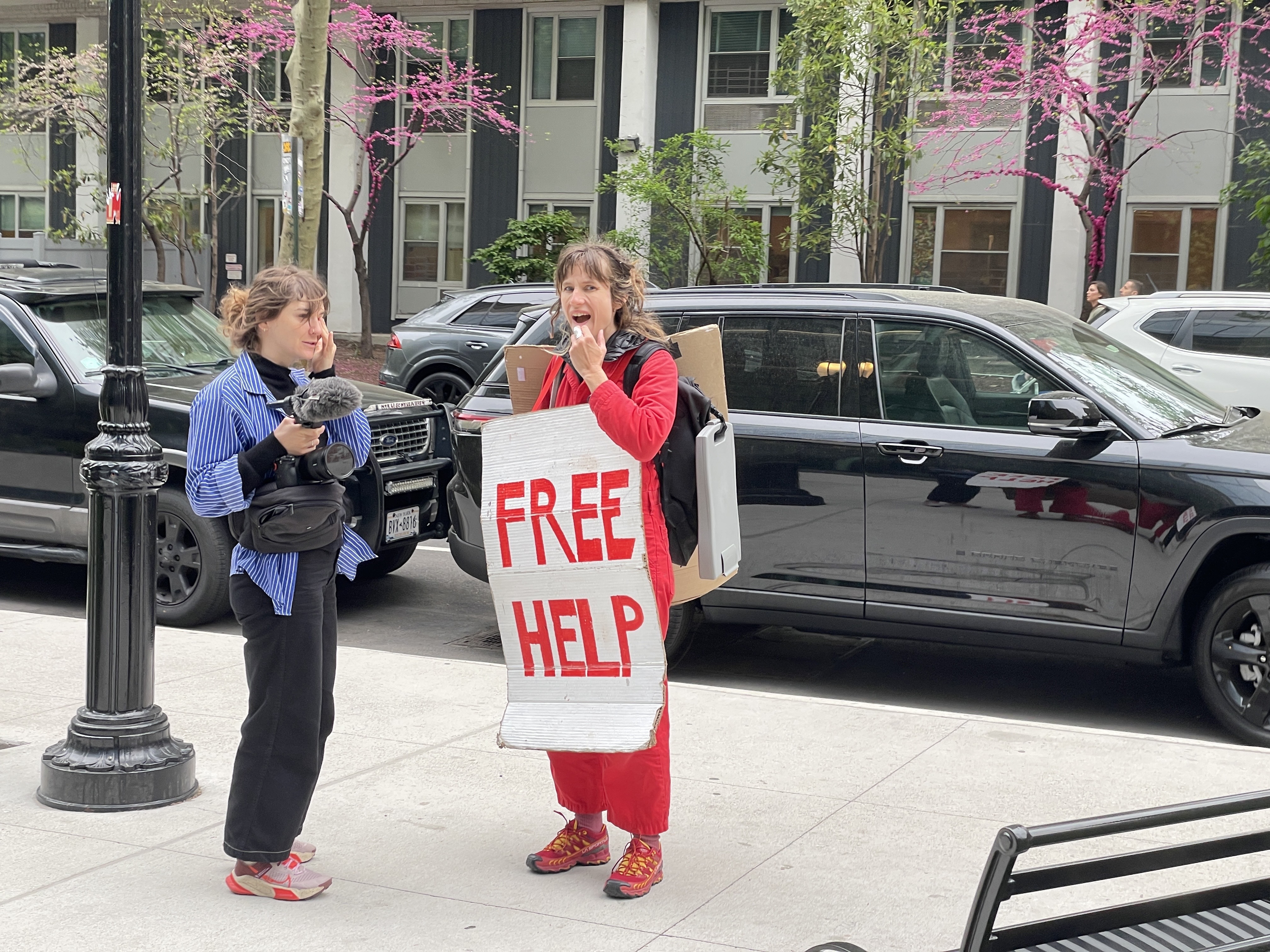 A woman wearing a sign that says "free help"