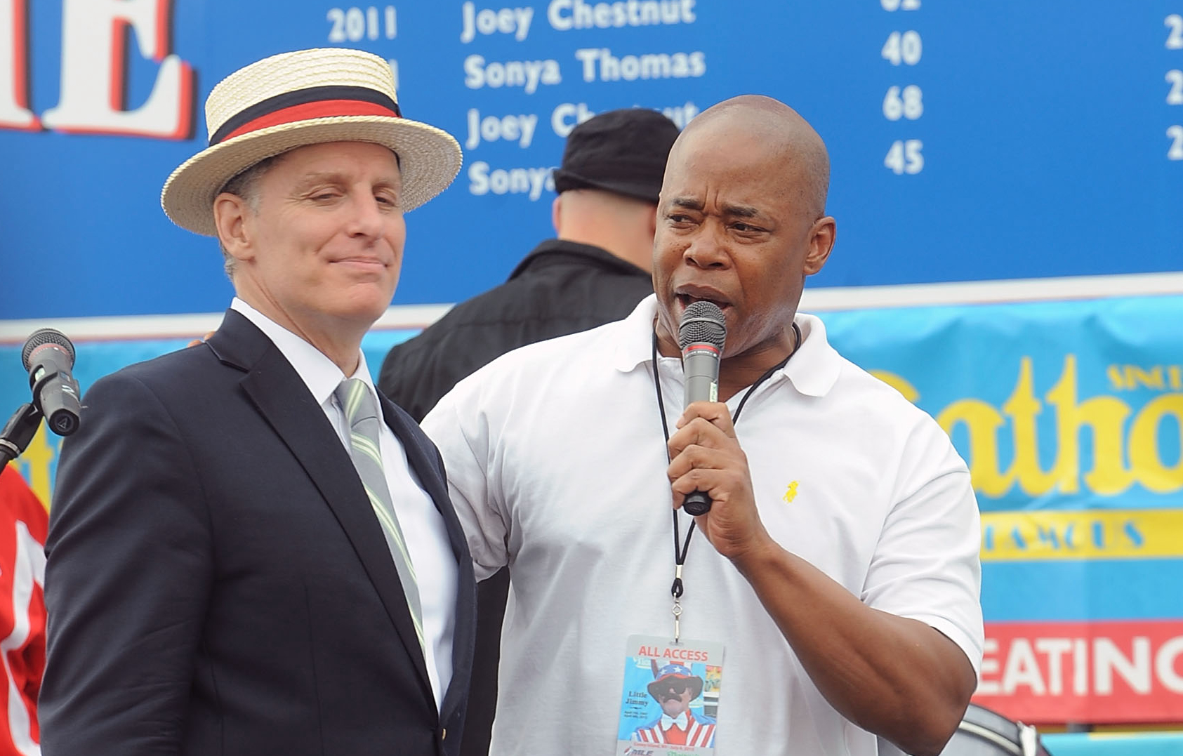 George Shea and Eric Adams, then-Brooklyn borough president, attends the 2015 Nathan's Famous 4th Of July International Hot Dog Eating Contest at Coney Island on July 4, 2015 in New York City.