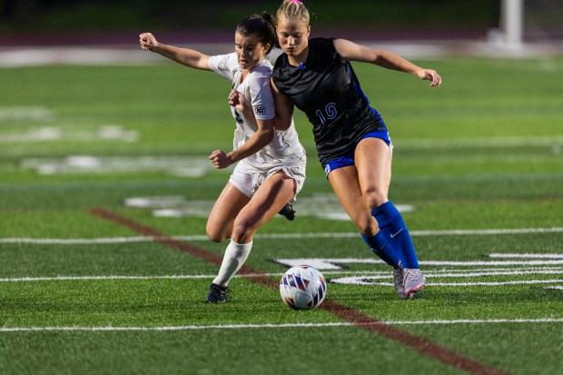 New Trier's Addy Randall, left, tries to beat St. Charles North's Chloe Kirsten (10) to the ball in the Class 3A championship game, at North Central College in Naperville on Saturday, June 1, 2024. (Vincent D. Johnson/for the Beacon-News)