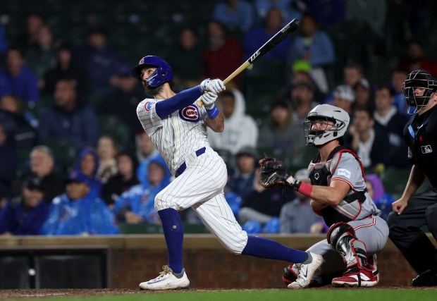 Chicago Cubs shortstop Dansby Swanson (7) hits a 2-run home run in the 8th inning of a game against the Cincinnati Reds at Wrigley Field in Chicago on June 2, 2024. (Chris Sweda/Chicago Tribune)