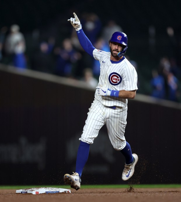 Chicago Cubs shortstop Dansby Swanson (7) celebrates as he rounds the bases after hitting a 2-run home run in the 8th inning of a game against the Cincinnati Reds at Wrigley Field in Chicago on June 2, 2024. (Chris Sweda/Chicago Tribune)