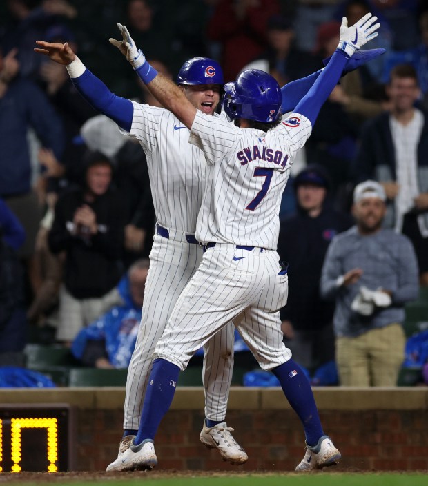 Chicago Cubs shortstop Dansby Swanson (7) celebrates with teammate Nico Hoerner after Swanson hit a 2-run home run in the 8th inning of a game against the Cincinnati Reds at Wrigley Field in Chicago on June 2, 2024. (Chris Sweda/Chicago Tribune)