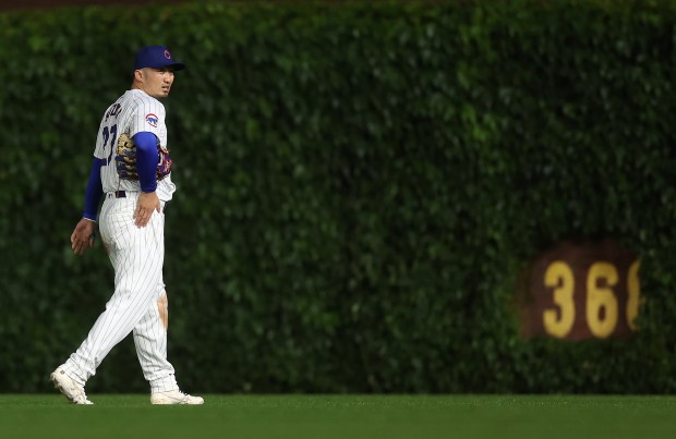 Chicago Cubs right fielder Seiya Suzuki (27) walks back to his position after making a costly error on a routine fly ball in the second inning of a game against the Cincinnati Reds at Wrigley Field in Chicago on June 1, 2024. (Chris Sweda/Chicago Tribune)