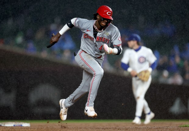 Cincinnati Reds shortstop Elly De La Cruz (44) takes off for third base before being tagged out in the fourth inning of a game against the Chicago Cubs at Wrigley Field in Chicago on June 1, 2024. (Chris Sweda/Chicago Tribune)