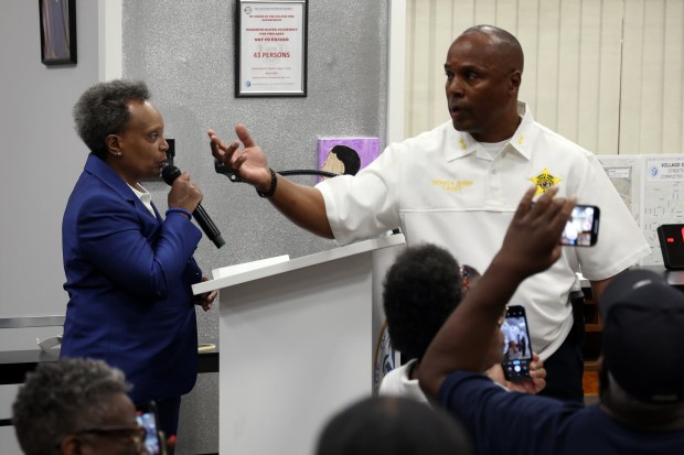 As former Chicago Mayor Lori Lightfoot attempts to speak during a Dolton Village Board June 3, 2024, Dolton Deputy Chief Lewis Lacey orders police to clear the room. (Terrence Antonio James/Chicago Tribune)