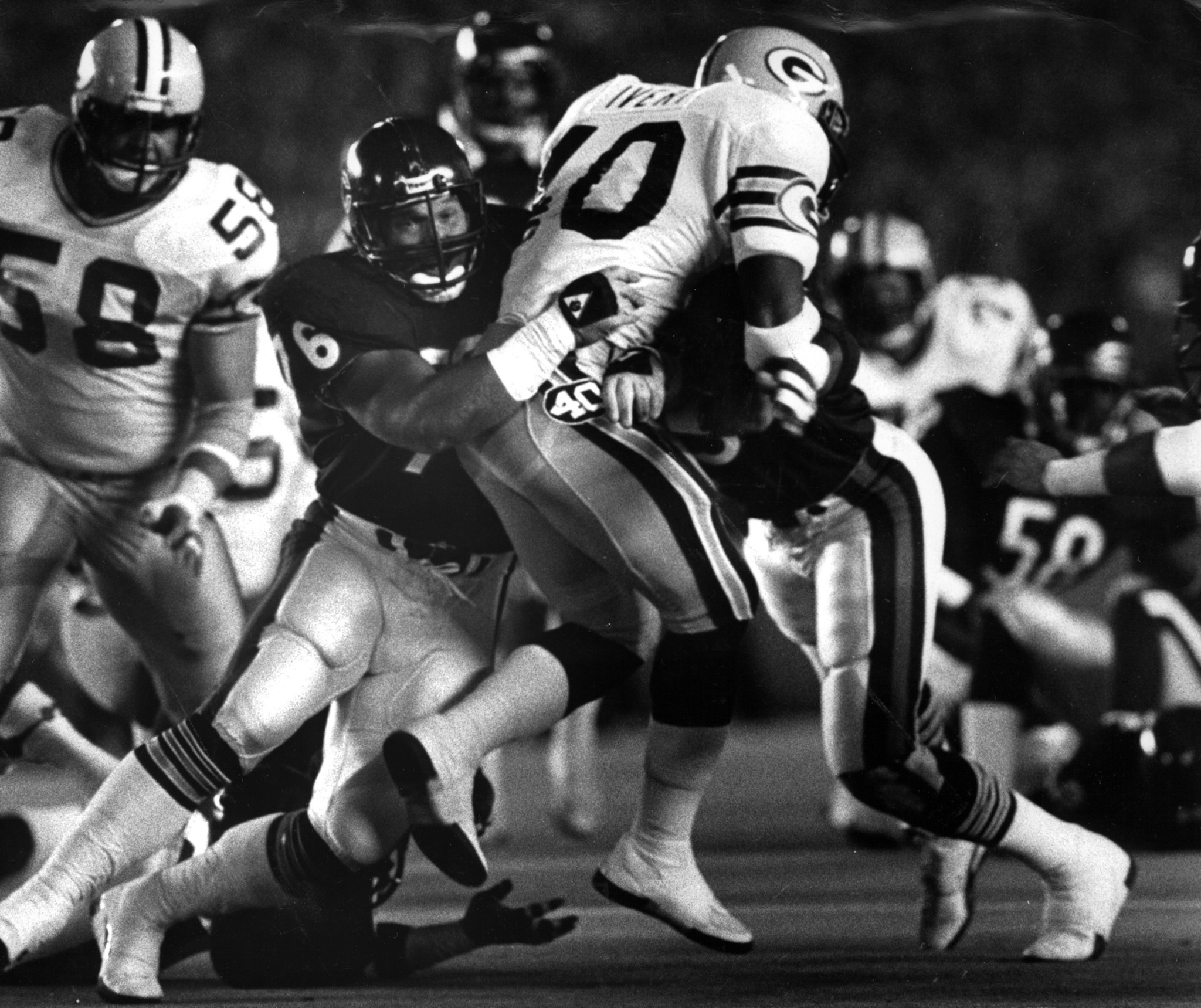 Bears' lineman Steve McMichael helps bring down Packer running back...