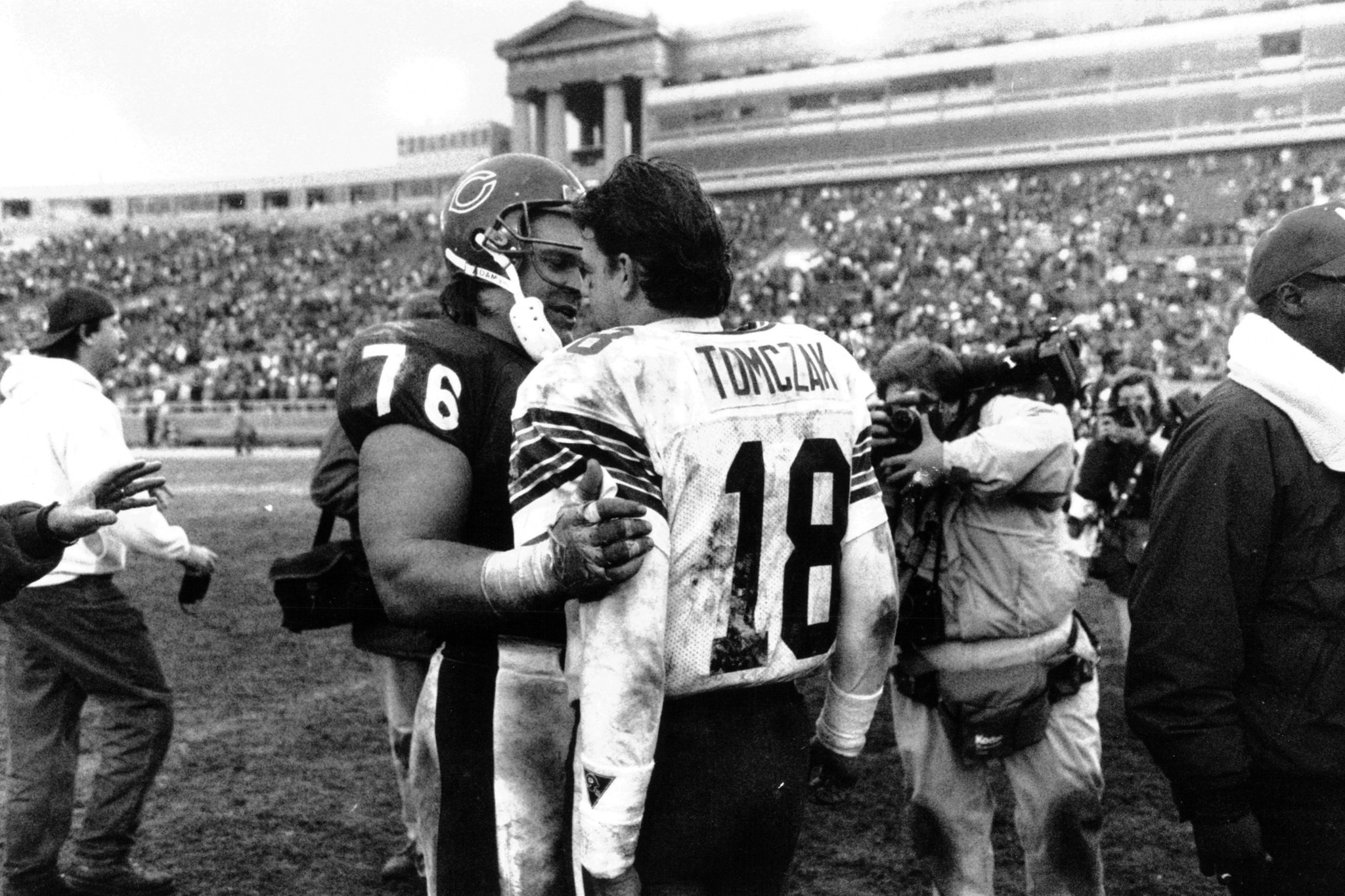 Former Bear Mike Tomczak (18) is greeted after the game...