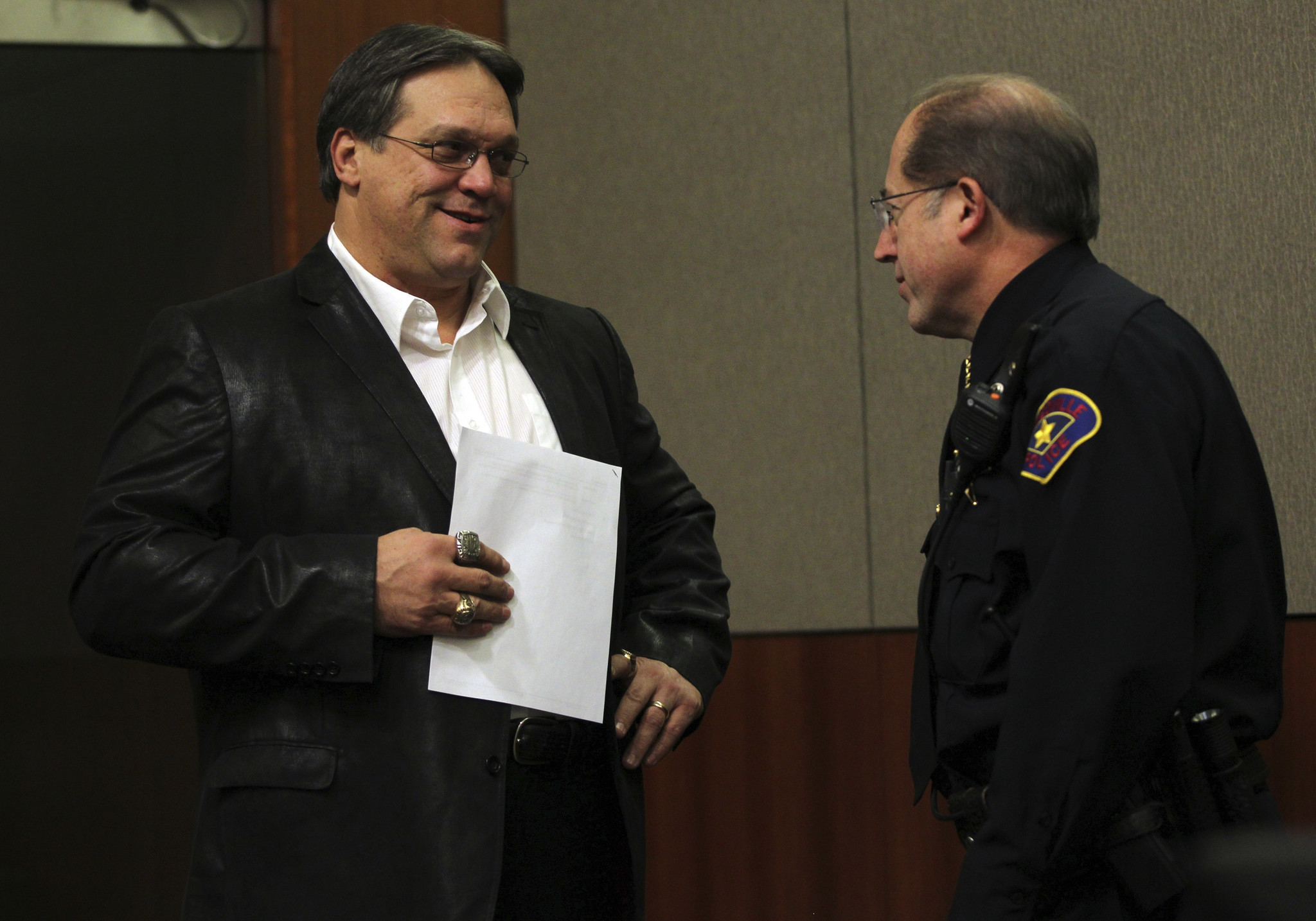 Steve McMichael chats with Police Chief Mark Turvey as McMichael...