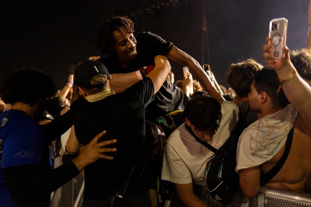 A festival goer is voluntarily removed by security from the pit due to overcrowding, June 14, 2024, at the Summer Smash Music Festival at SeatGeek Stadium in Bridgeview. (Vincent Alban/Chicago Tribune)