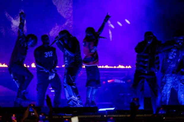 Travis Scott, in the red and blue striped shirt, and other members of the record label Cactus Jack, perform, June 14, 2024, at the Summer Smash Music Festival at SeatGeek Stadium in Bridgeview. (Vincent Alban/Chicago Tribune)