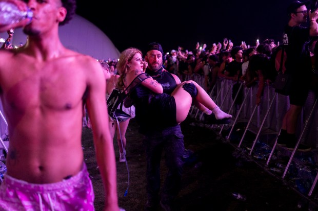 A festival goer is voluntarily removed by security from the pit due to overcrowding on Friday, June 14, 2024, at the Summer Smash Music Festival at SeatGeek Stadium in Bridgeview, Ill.(Vincent Alban/Chicago Tribune)