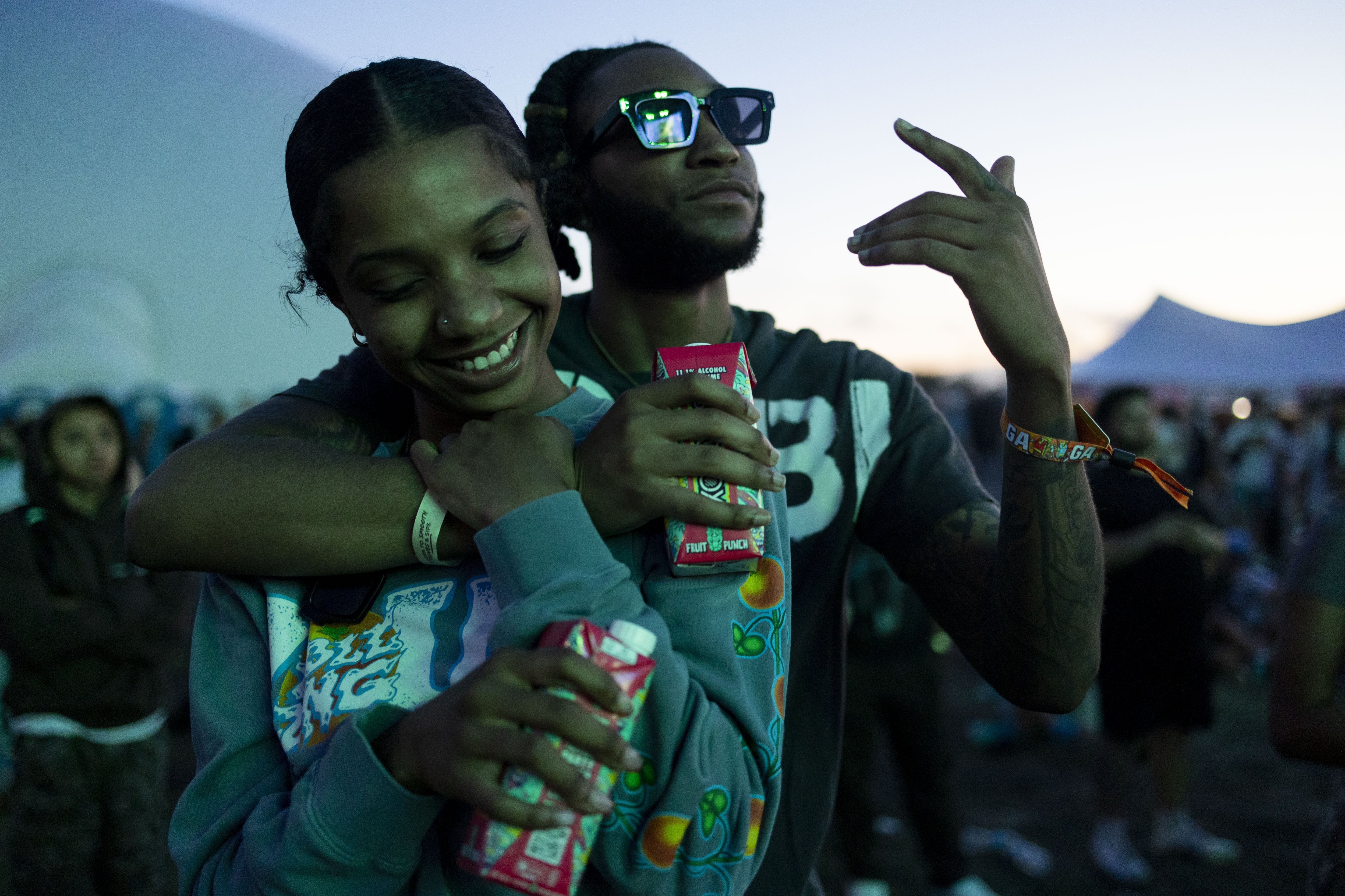 Lonvon Easley, left, and Kobe Jones, embrace while listening to...