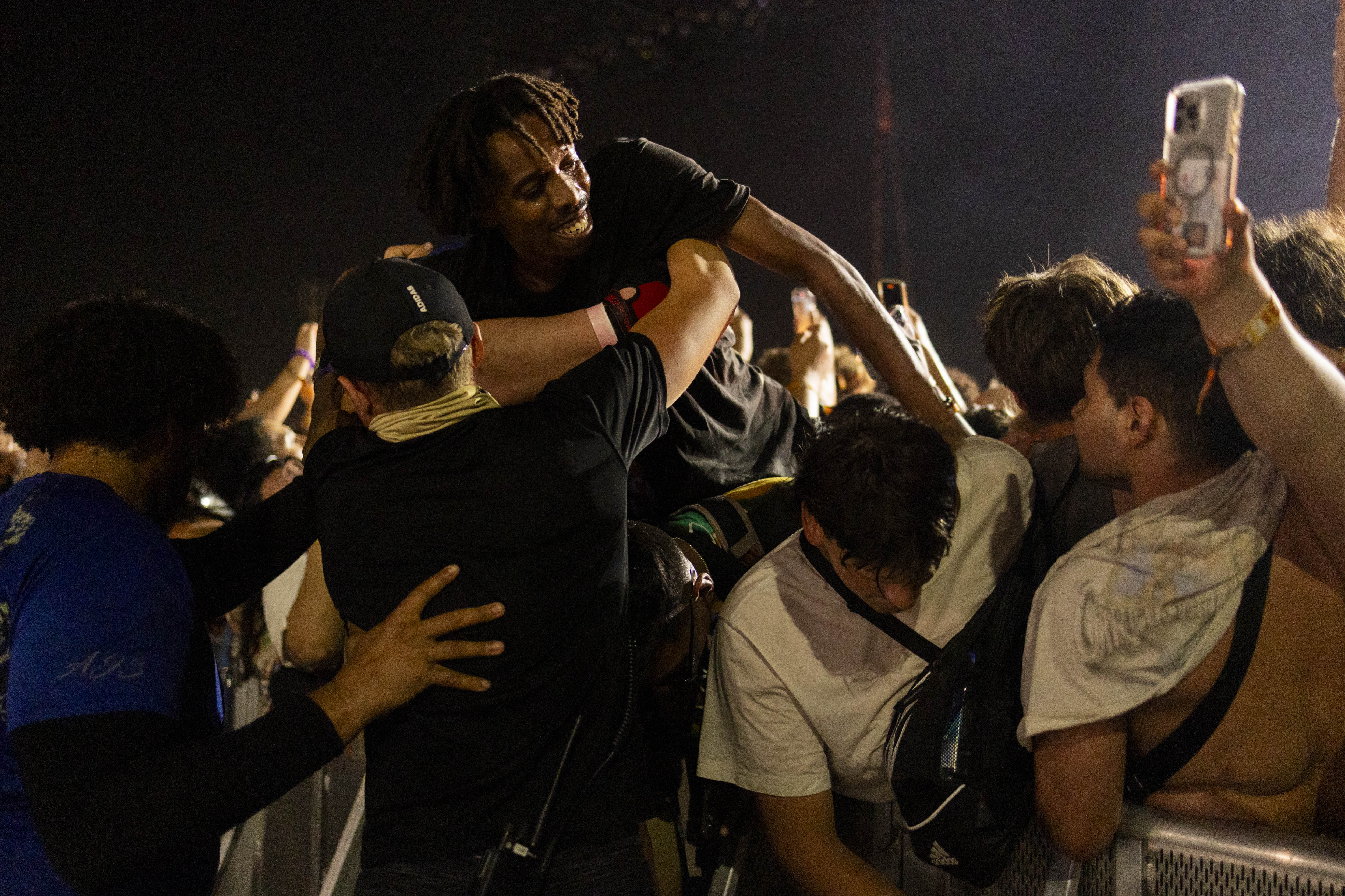 A festival goer is voluntarily removed by security from the...