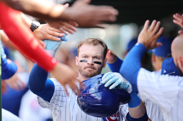 Ian Happ #8 of the Chicago Cubs high fives teammates after hitting a three-run home run off John King #47 of the St. Louis Cardinals (not pictured) during the seventh inning at Wrigley Field on June 15, 2024 in Chicago, Illinois. (Photo by Michael Reaves/Getty Images)