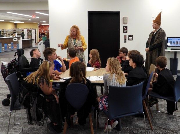 Darwin Gillespie, dressed as a wizard, watches over a "School of Magic" class at the Antioch Public Library. The classes were one of the attractions at Wizards Weekend Day. (Antioch Public Library/Hannah Sator)