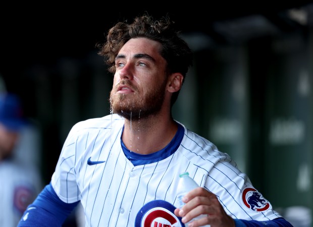 Chicago Cubs outfielder Cody Bellinger (24) pours water on himself to cool off on a hot and humid 95 degree day before the start of a game between the Chicago Cubs and San Francisco Giants at Wrigley Field on June 16, 2024, in Chicago. (Stacey Wescott/Chicago Tribune)