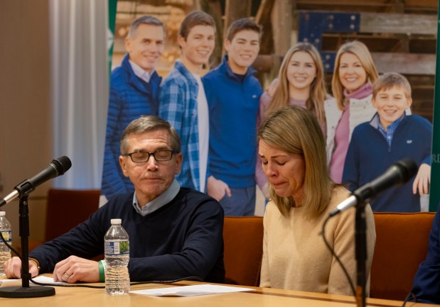 Brian and Kristine Richards speak on Dec. 13, 2023, in front of a family portrait about the death of their 14-year-old son, Sean Richards, pictured at right, in an accident in July at Fuller's Car Wash in Hinsdale.