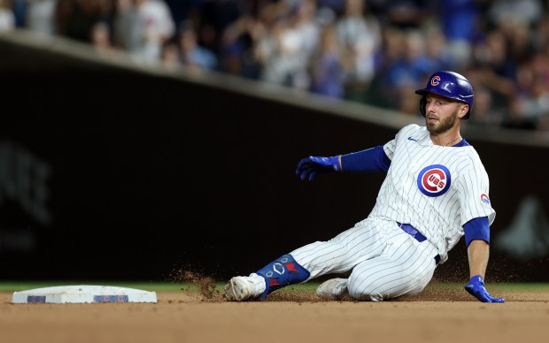 Chicago Cubs first baseman Michael Busch slides in safely at second base on a double in the 8th inning of a game against the San Francisco Giants at Wrigley Field in Chicago on June 18, 2024. (Chris Sweda/Chicago Tribune)