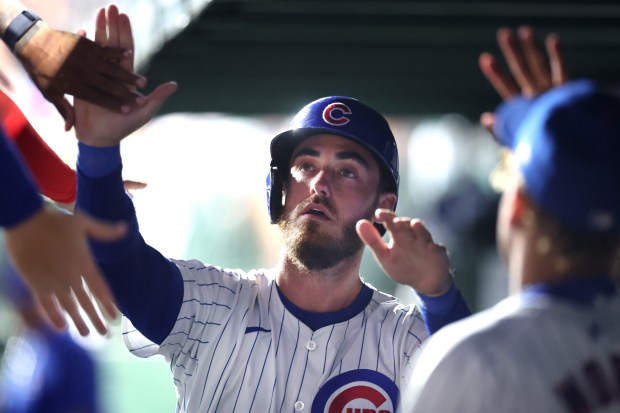 Chicago Cubs right fielder Cody Bellinger is congratulated by his teammates in the dugout after scoring a run in the 8th inning of a game against the San Francisco Giants at Wrigley Field in Chicago on June 18, 2024. (Chris Sweda/Chicago Tribune)