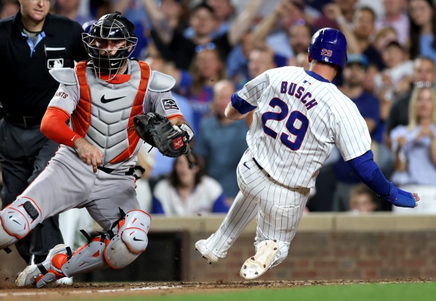 Chicago Cubs first baseman Michael Busch (29) slides in safely at home on a single by Cody Bellinger in the 8th inning of a game against the San Francisco Giants at Wrigley Field in Chicago on June 18, 2024. (Chris Sweda/Chicago Tribune)