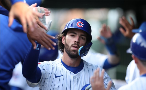 Chicago Cubs shortstop Dansby Swanson is congratulated by his teammates in the dugout after hitting a 2-run home run in the second inning of a game against the San Francisco Giants at Wrigley Field in Chicago on June 18, 2024. (Chris Sweda/Chicago Tribune)