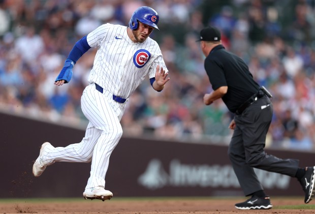 Chicago Cubs first baseman Michael Busch sprints to third base on a single by teammate Cody Bellinger in the third inning of a game against the San Francisco Giants at Wrigley Field in Chicago on June 18, 2024. (Chris Sweda/Chicago Tribune)