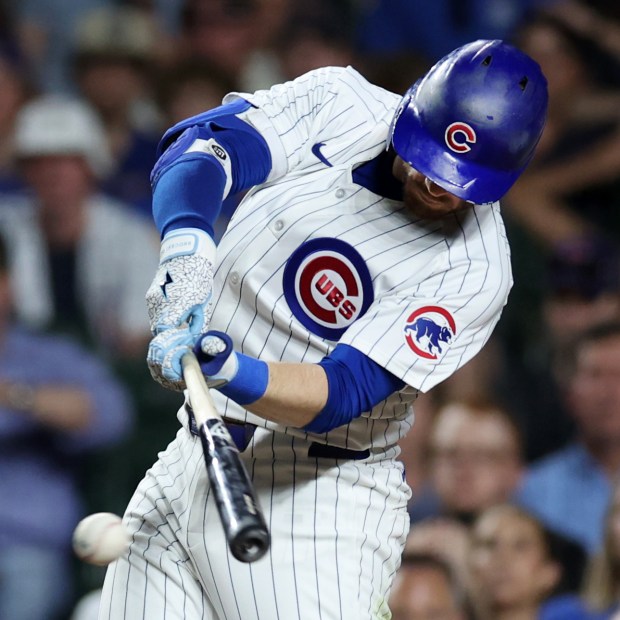 Chicago Cubs left fielder Ian Happ (8) drives in a run on a single in the 8th inning of a game against the San Francisco Giants at Wrigley Field in Chicago on June 18, 2024. (Chris Sweda/Chicago Tribune)