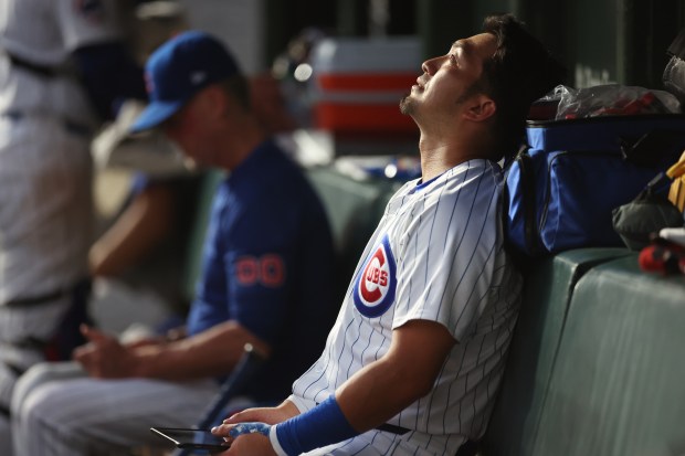 Chicago Cubs designated hitter Seiya Suzuki sits in the dugout after flying out deep with the bases loaded to end the fifth inning of a game against the San Francisco Giants at Wrigley Field in Chicago on June 18, 2024. (Chris Sweda/Chicago Tribune)