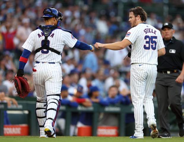 Chicago Cubs catcher Miguel Amaya (9) and starting pitcher Justin Steele (35) congratulate one another after shutting down the San Francisco Giants in the first inning of a game at Wrigley Field in Chicago on June 18, 2024. (Chris Sweda/Chicago Tribune)