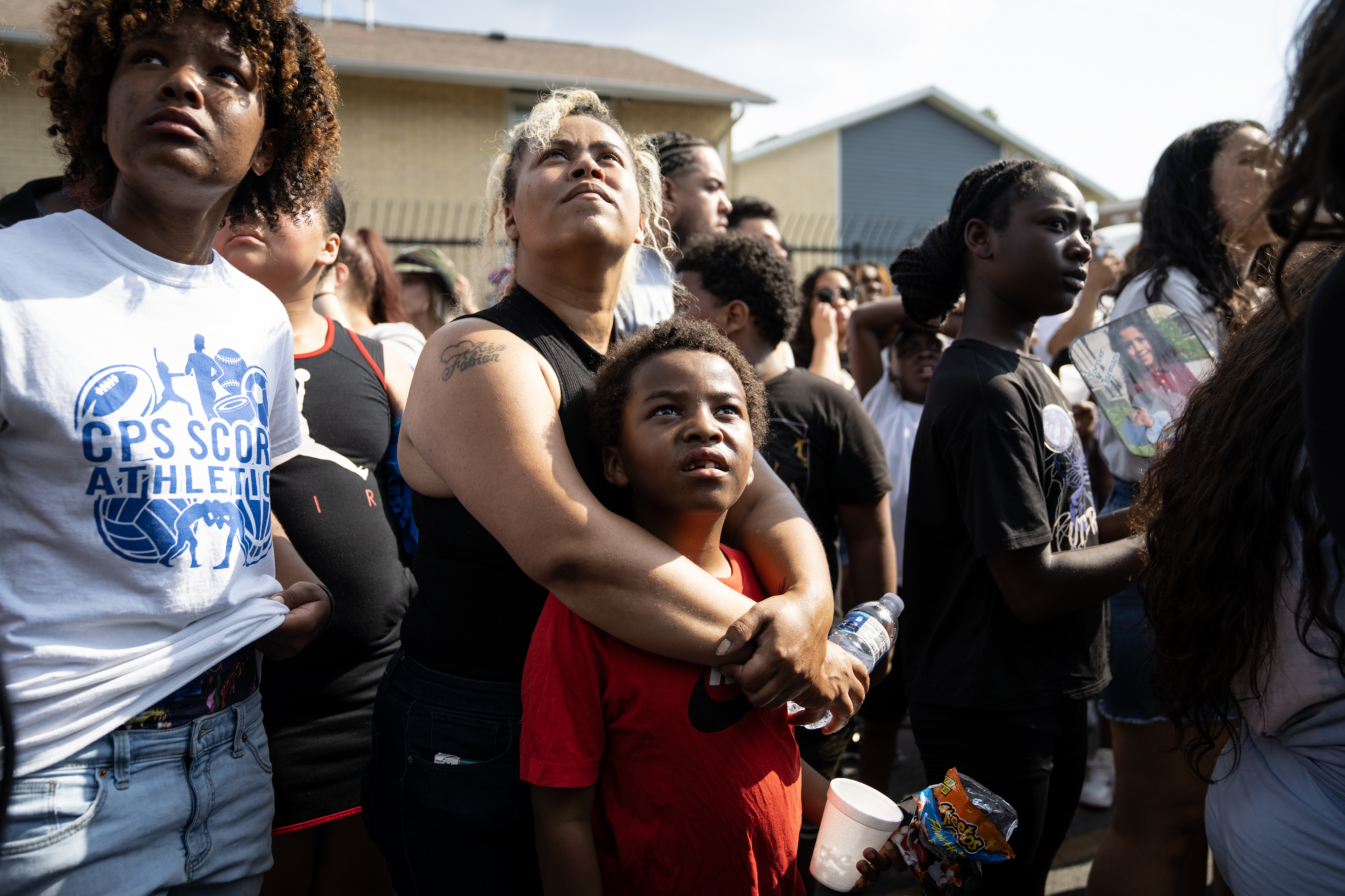 Friends and family watch a balloon release during a vigil...