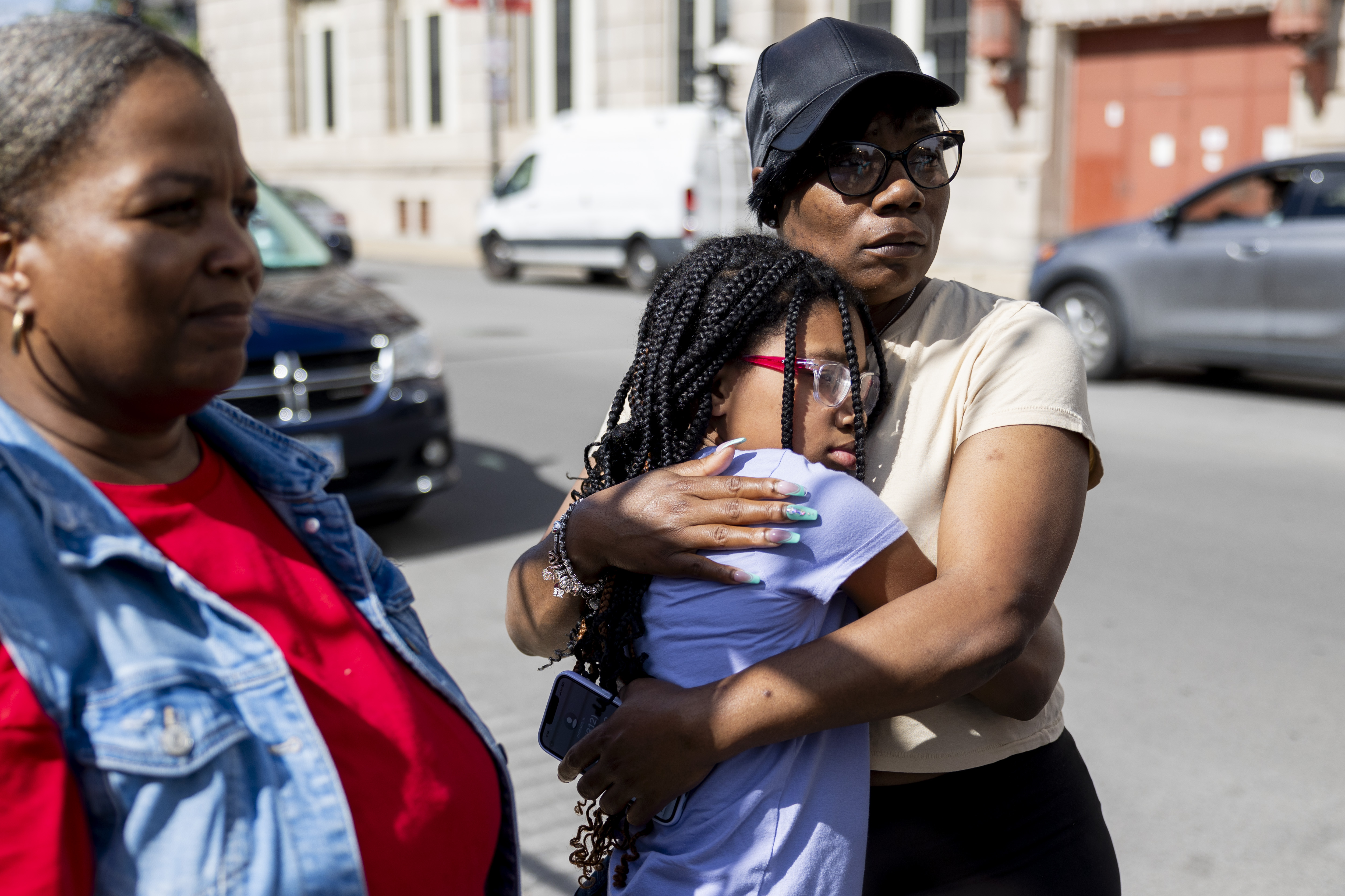 Ethiopia Jackson, right, and Samiram Dyson, 11, both residents of the Oakley Square apartment complex, hug on June 18, 2024, after the fatal shooting of 7-year-old Jaimani Amir Rivera. (Vincent Alban/Chicago Tribune)