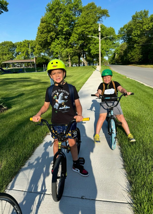 Beiriger Elementary students Grayson (left) and Liam Butkus bike to and from school as part of the "bike bus" program. (Jim Masters/Post-Tribune)