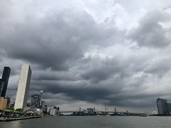 Clouds over The East River this afternoon. The tall white building on the left is The United Nations Building.