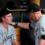 Chicago White Sox pitcher Jonathan Cannon, left, listens to manager Pedro Grifol (5) in the dugout in the second inning of a baseball game against the Detroit Tigers, Sunday, June 23, 2024, in Detroit. (AP Photo/Paul Sancya)