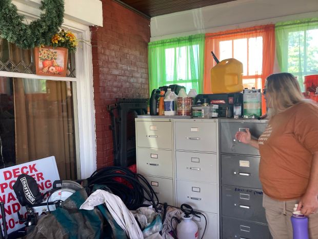 Joy Magill stands next to the filing cabinets in her enclosed porch that still contain bullets from shots fired into her home on April 27 (Denise Crosby)