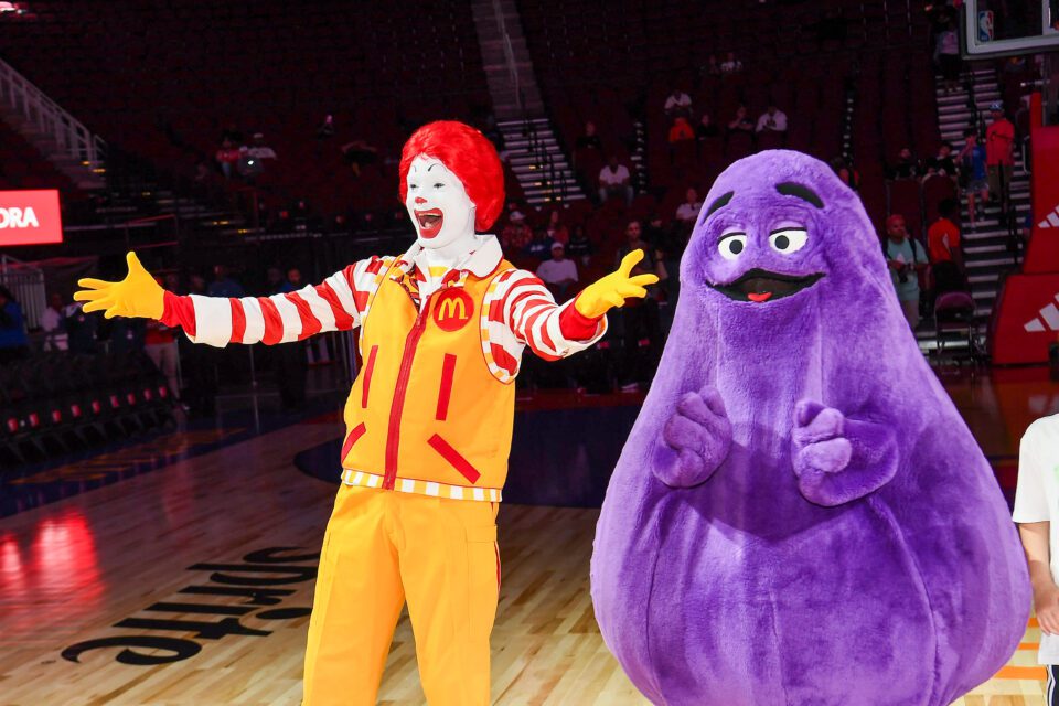 Grimace, a McDonalds' mascot, standing next to Ronald McDonald.