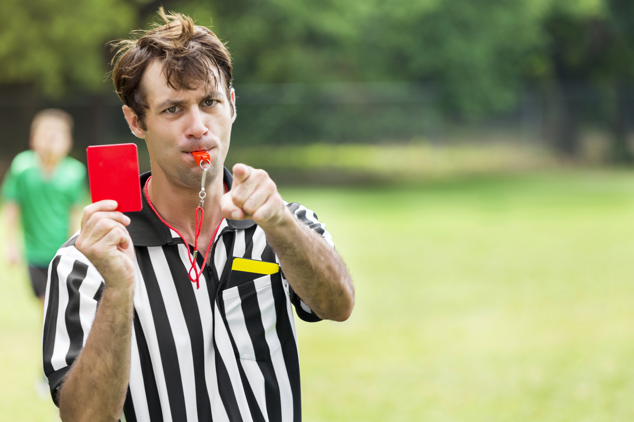 a referee holds up a red card