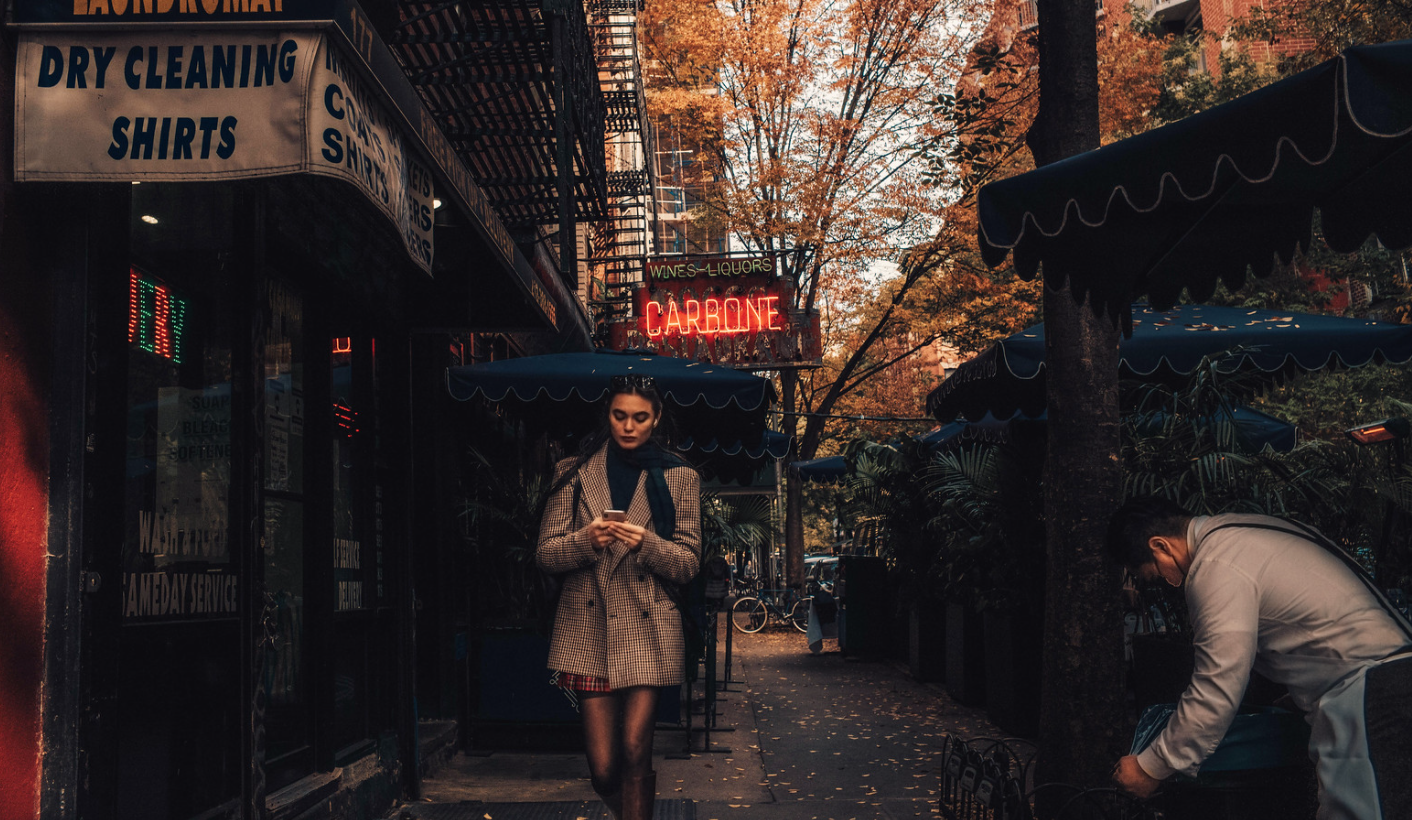 A photo of a woman walking past Carbone