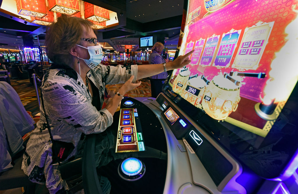 A gambler tries her luck on a slot machine at Rivers Casino and Resort Schenectady, on Sept. 9, 2020, in the upstate New York town.