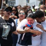 Vanessa Rivera, second from right, holds a Spider-Man toy as she is comforted during a march for peace on West Jackson Boulevard in Chicago on June 21, 2024, near the Oakley Square apartment complex where her nephew Jai'Mani Amir Rivera was killed Tuesday. (Terrence Antonio James/Chicago Tribune)