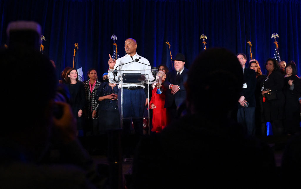 Eric Adams speaks at a podium surrounded by supporters on November 2, 2021, the day he won the election for mayor.