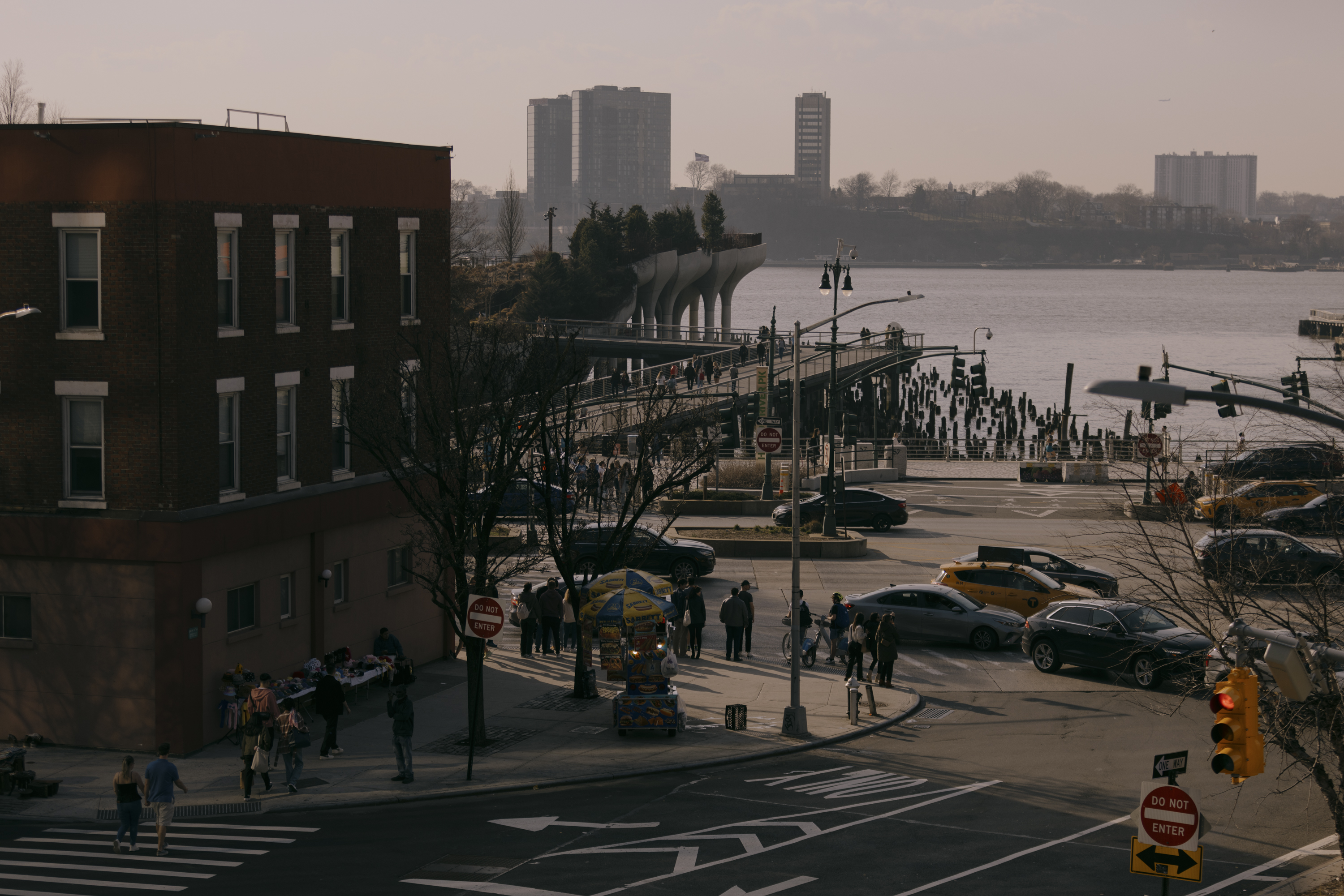 Traffic navigates the bustling intersection of West 14th Street and 10th Avenue in Manhattan.