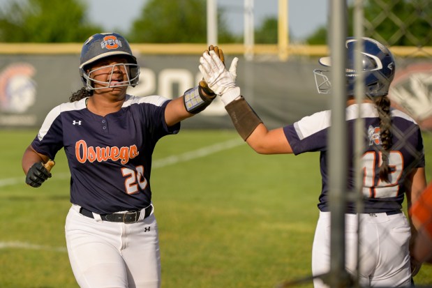 Oswego's Jaelynn Anthony (20) celebrates her RBI single to take the lead over Wheaton North in the 8th inning, with Ella Boling (13), during the Class 4A Plainfield North Sectional final in Plainfield on Friday, May 31, 2024. (Mark Black / for the Beacon-News)