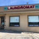 The facade of Star Laundromat on Staten Island, It's a quiet scene with none out front and no cars in the parking lot.