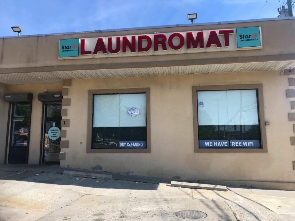 The facade of Star Laundromat on Staten Island, It's a quiet scene with none out front and no cars in the parking lot.